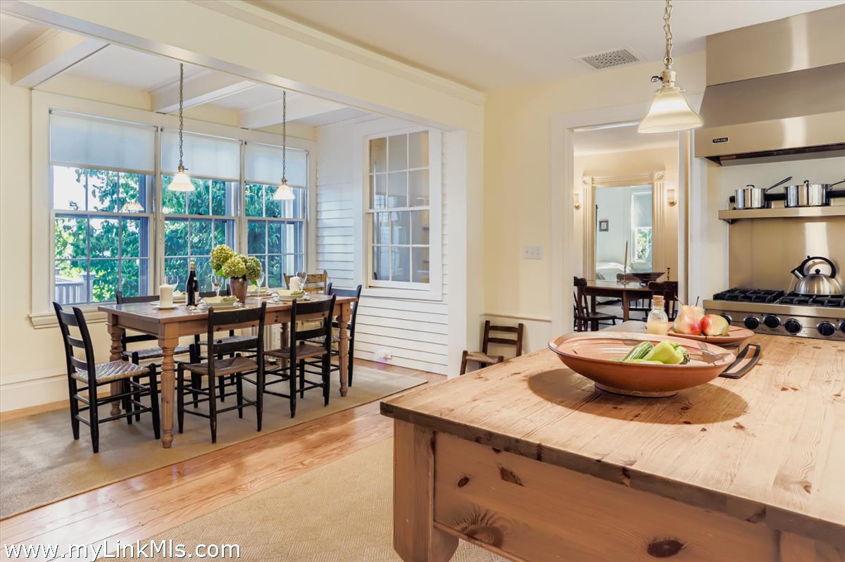 27 Spring Street Vineyard Haven, MA 02568 - Photo 12 of 58 a dining room with furniture large windows and a chandelier