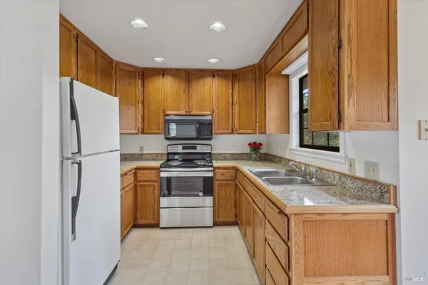 a spacious bedroom with a bed and a window