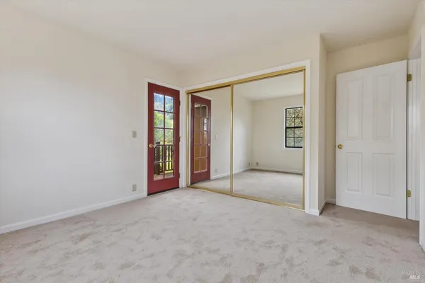 a view of a kitchen with wooden floor and a refrigerator