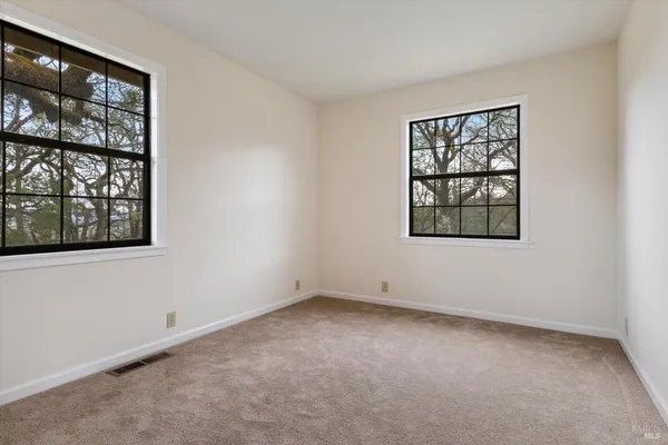 a view of a yard with a house in the background