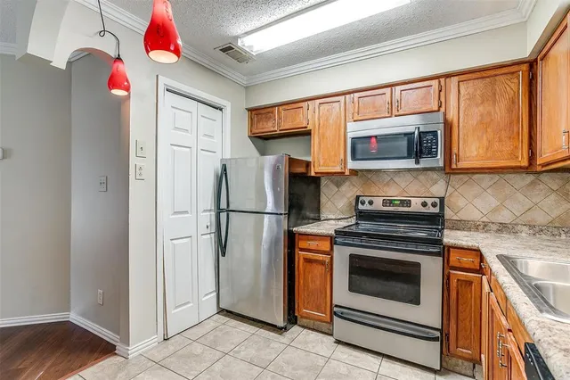 a kitchen with stainless steel appliances granite countertop a refrigerator stove and sink
