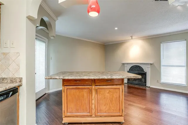 a room with a stove and a wooden floor