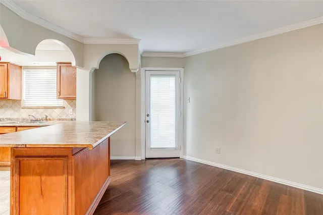 a view of a kitchen cabinets a sink and wooden floor