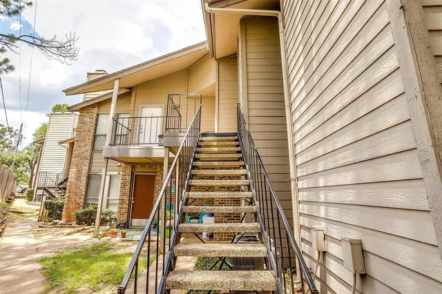 a front view of a house with a iron gate
