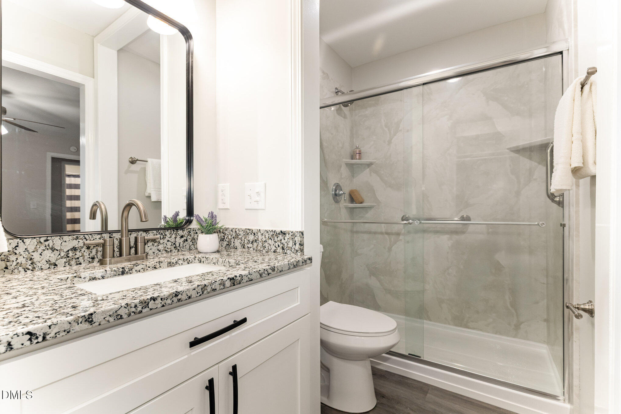 7717 Cart Track Trail Raleigh, NC 27615 - Photo 14 of 18 a bathroom with a granite countertop sink toilet and shower