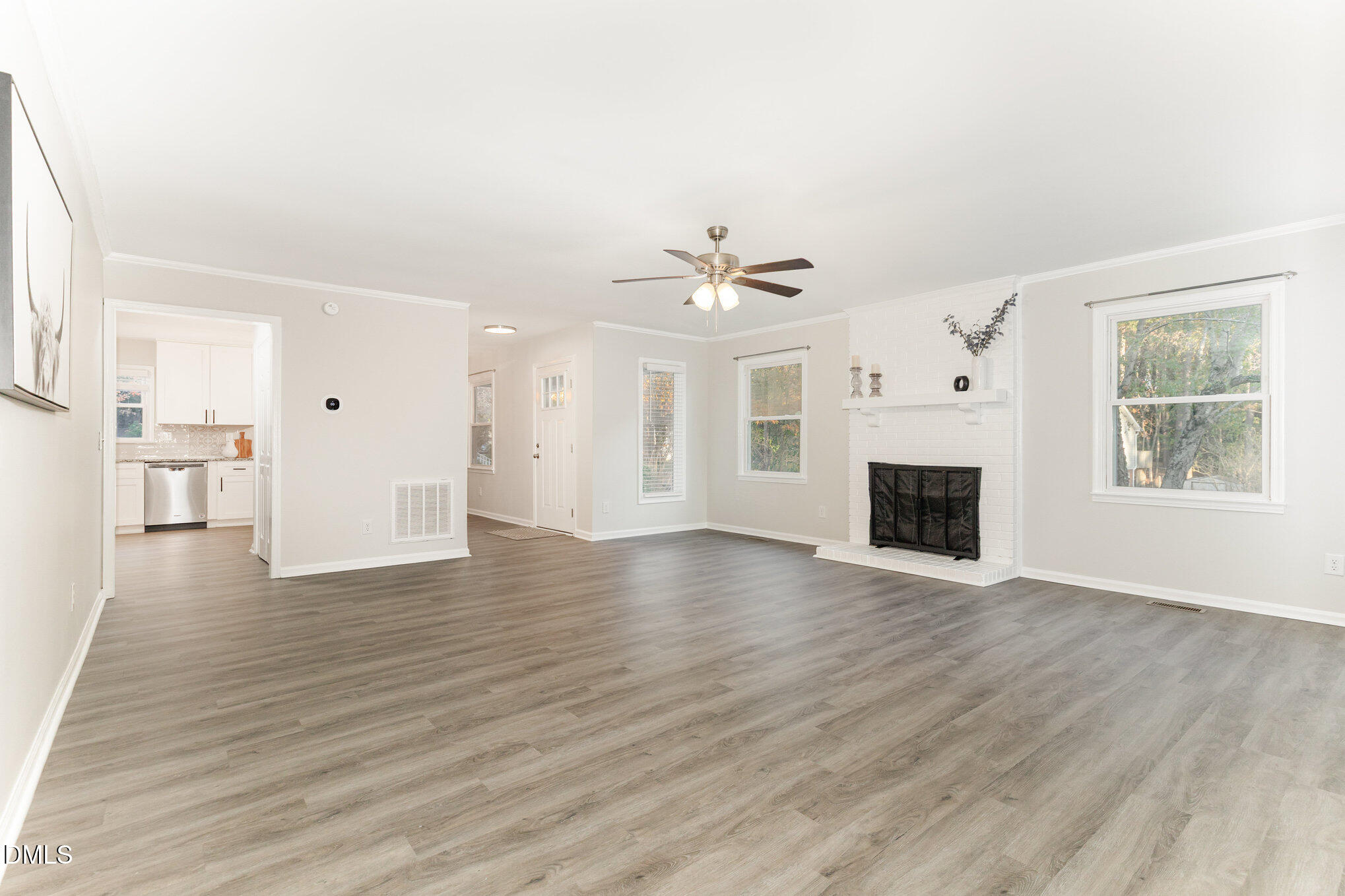 7717 Cart Track Trail Raleigh, NC 27615 - Photo 6 of 18 a view of a livingroom with wooden floor and a fireplace
