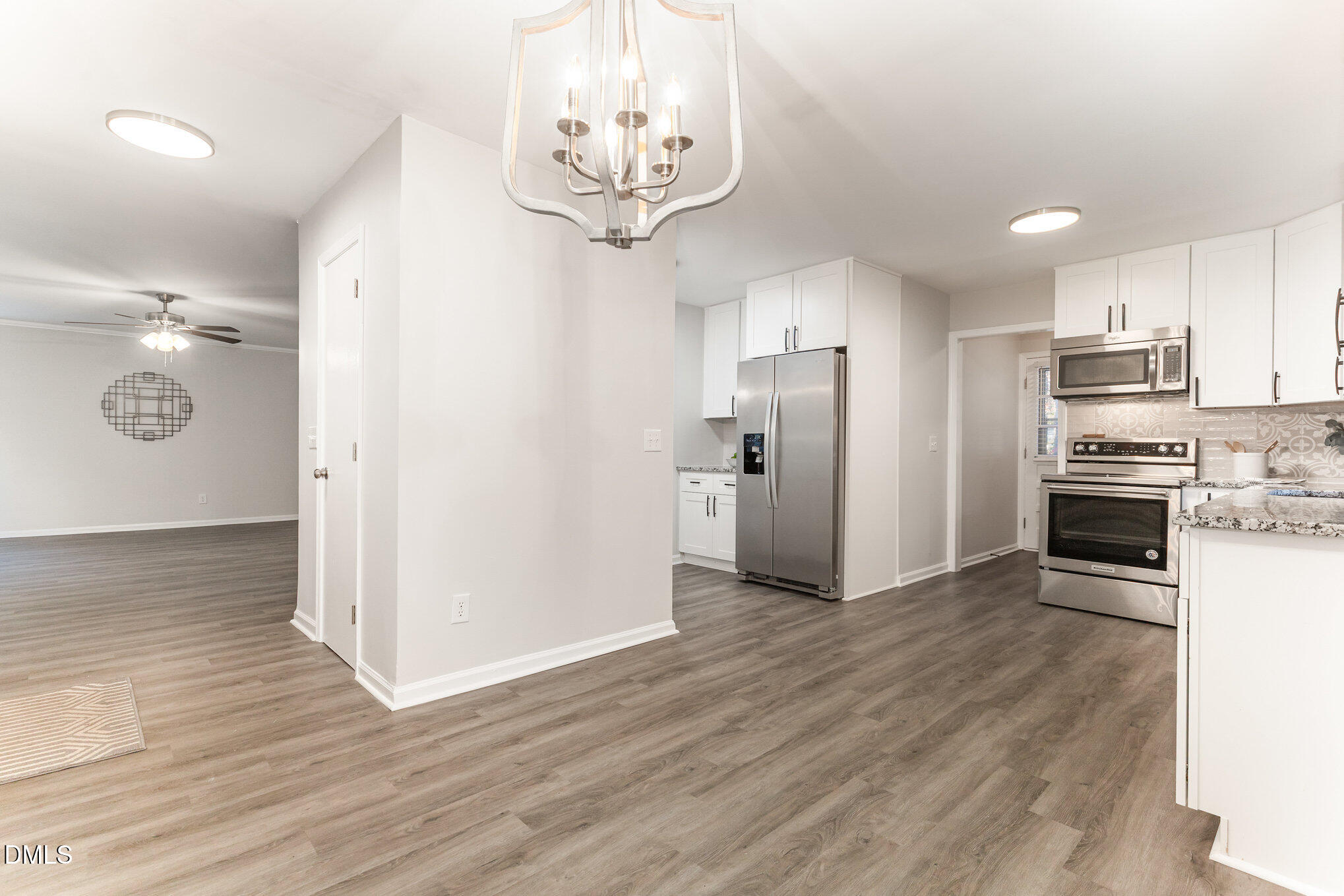 7717 Cart Track Trail Raleigh, NC 27615 - Photo 8 of 18 a view of a kitchen with stainless steel appliances a refrigerator and wooden floor