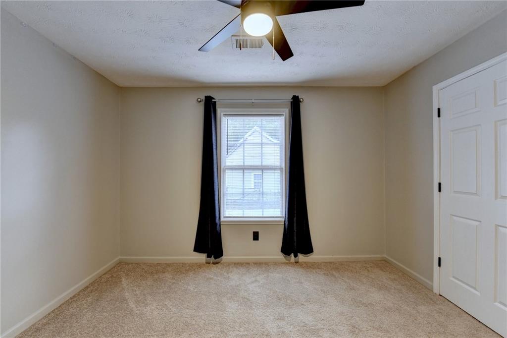 801 Davis Street Monroe, GA 30655 - Photo 20 of 33 an empty room with windows and closet