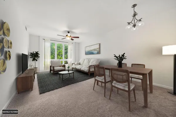 a living room with furniture and a potted plant