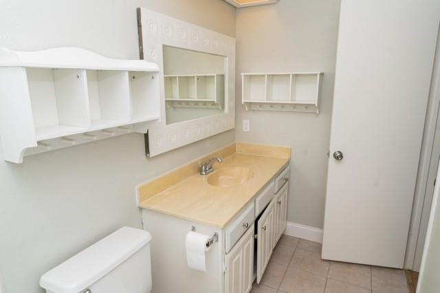 106 Mapleleaf Lane Coppell, TX 75019 - Photo 32 of 36 Bathroom featuring a vanity with a light-colored countertop, an integrated sink, and white cabinetry