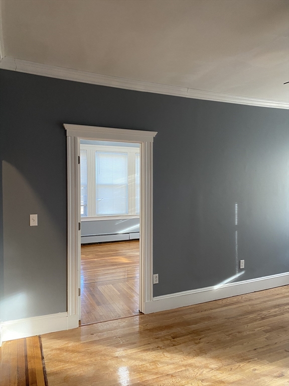 39 Pasadena Road, Unit 2 Boston, MA 02121 - Photo 11 of 29 a view of room with wooden floor