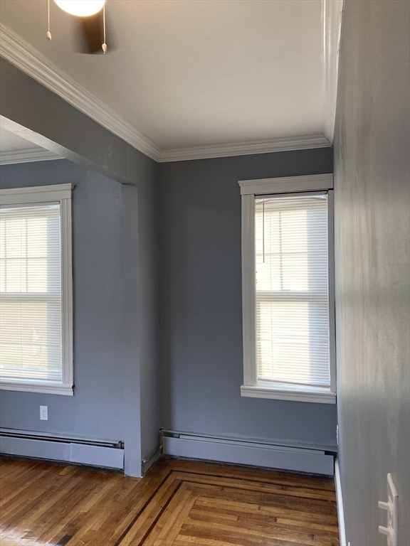 39 Pasadena Road, Unit 2 Boston, MA 02121 - Photo 12 of 29 a view of an empty room with wooden floor and a window