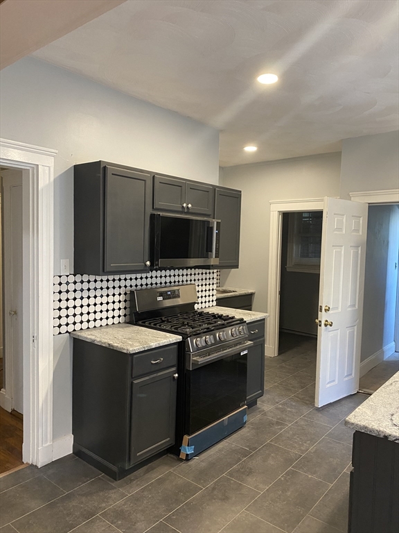 39 Pasadena Road, Unit 2 Boston, MA 02121 - Photo 19 of 29 a kitchen with a stove and a refrigerator