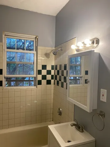 a bathroom with a bathtub and shower