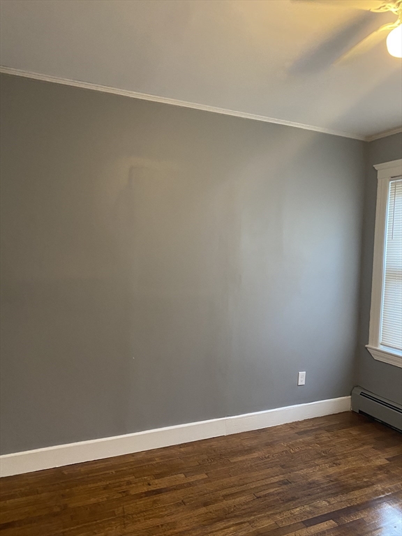 39 Pasadena Road, Unit 2 Boston, MA 02121 - Photo 27 of 29 a view of an empty room with wooden floor and a window