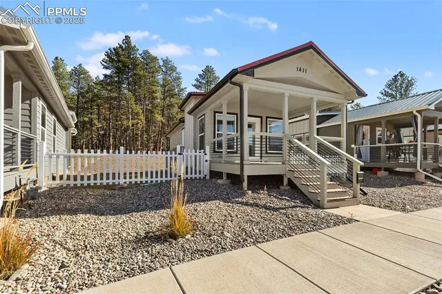 a view of a house with wooden fence