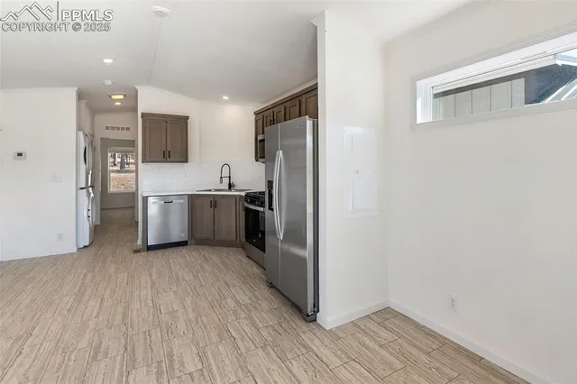 a kitchen with stainless steel appliances a refrigerator and a sink