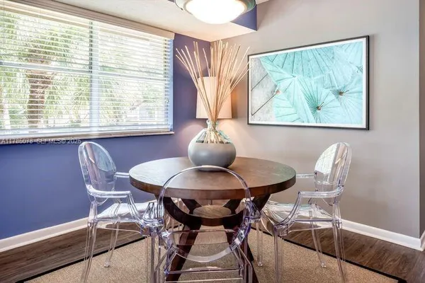 a dining room with furniture and window