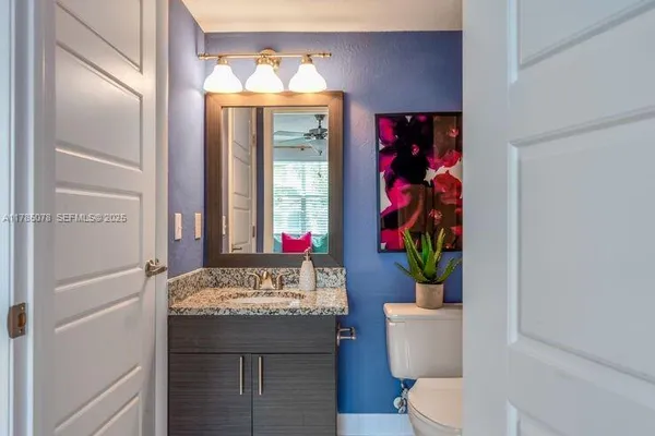 a view of bathroom with a toilet sink and mirror
