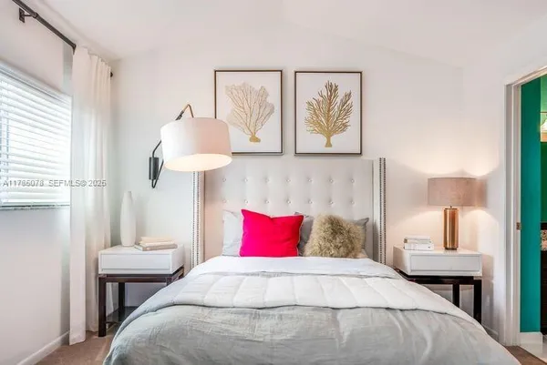 a bedroom with a bed and a table