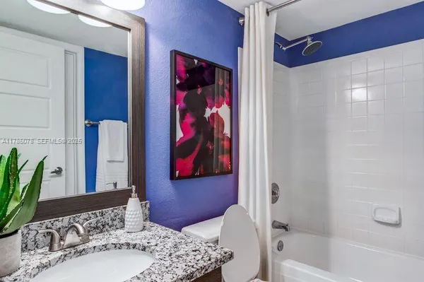 a bathroom with a bathtub and shower