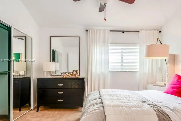 a bedroom with a bed and a dresser