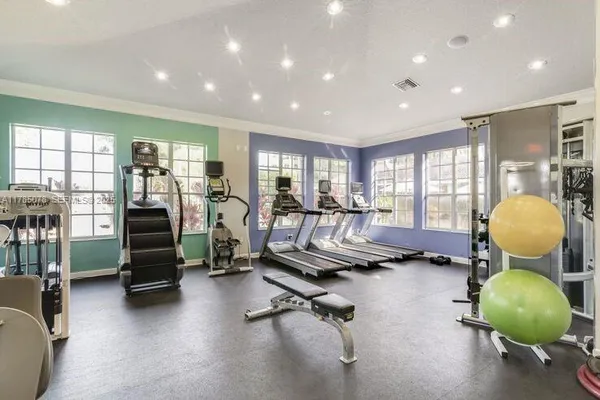 a room with gym equipment and a view of living room