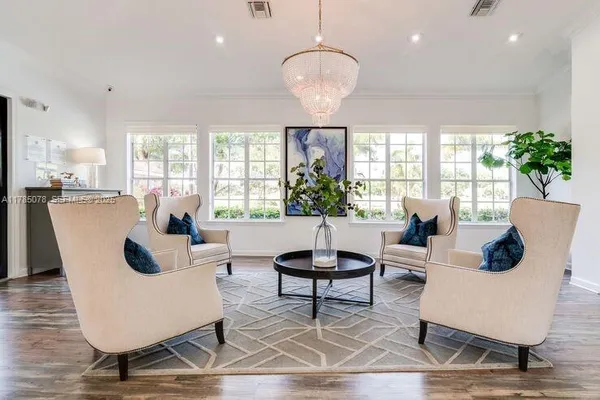 a living room with fireplace furniture and a large window