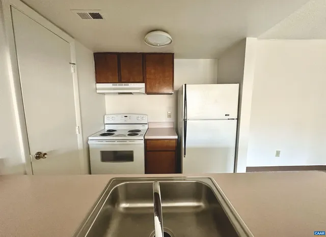 a kitchen with a refrigerator and a sink
