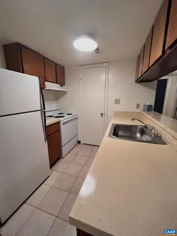 a kitchen with a refrigerator and a sink