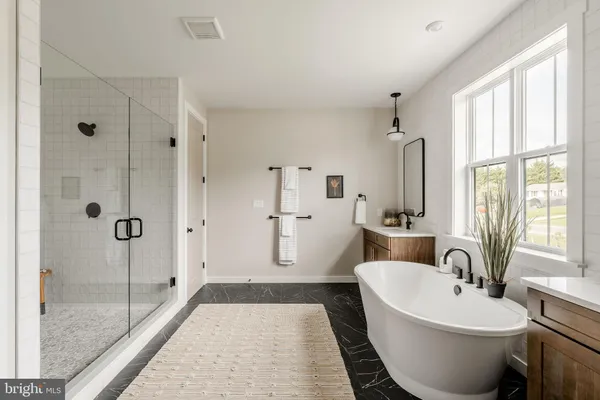 a spacious bathroom with a bathtub and a shower