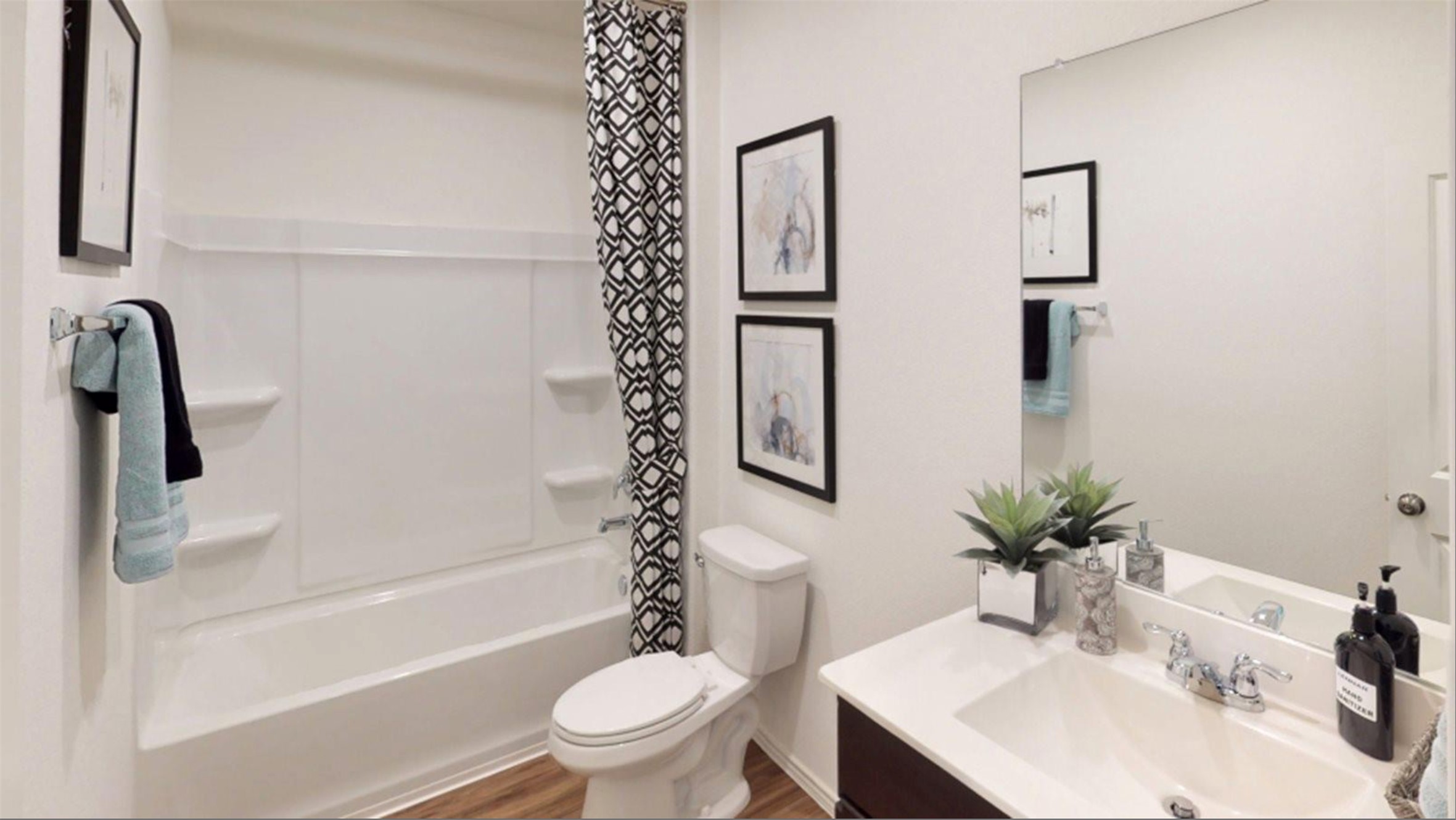2321 Forgetmenot Lane Manor, TX 78653 - Photo 15 of 27 A well-appointed bathroom offers a clean tub, modern vanity, and reflective surfaces.