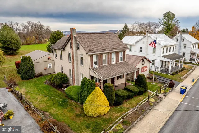 a aerial view of a house with table and chairs