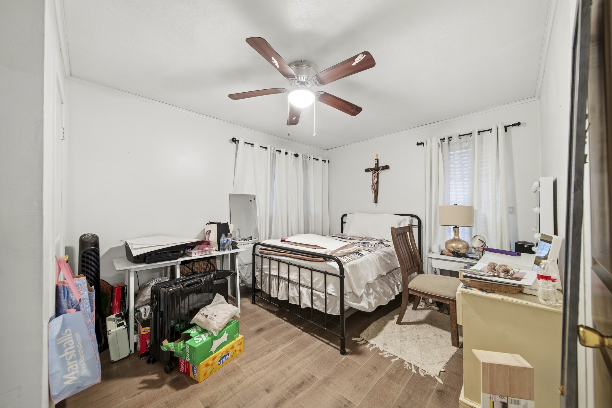731 Meneley Road Winnie, TX 77665 - Photo 20 of 27 a bedroom with a bed a ceiling fan and a dresser