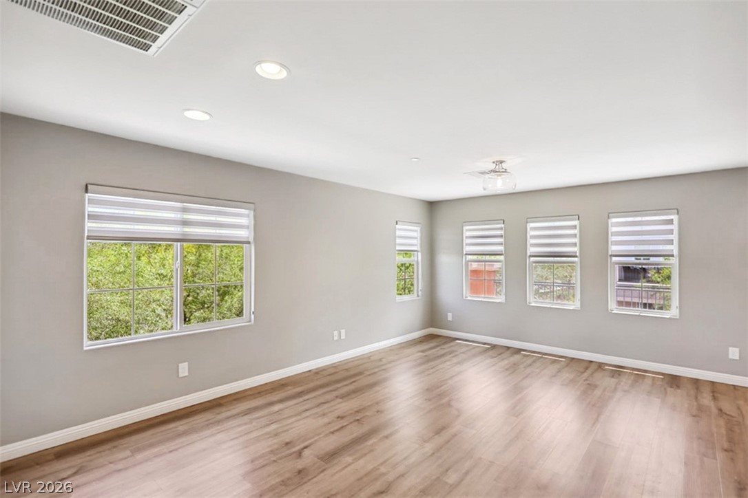9940 Sable Point Street Las Vegas, NV 89178 - Photo 25 of 40 Spare room featuring baseboards, wood finished floors, and recessed lighting