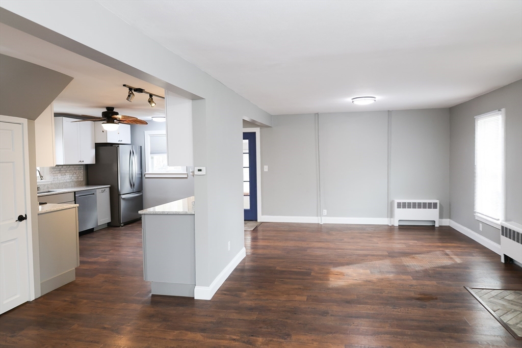 152 Central Street Georgetown, MA 01833 - Photo 11 of 26 a view of a kitchen with refrigerator and wooden floor