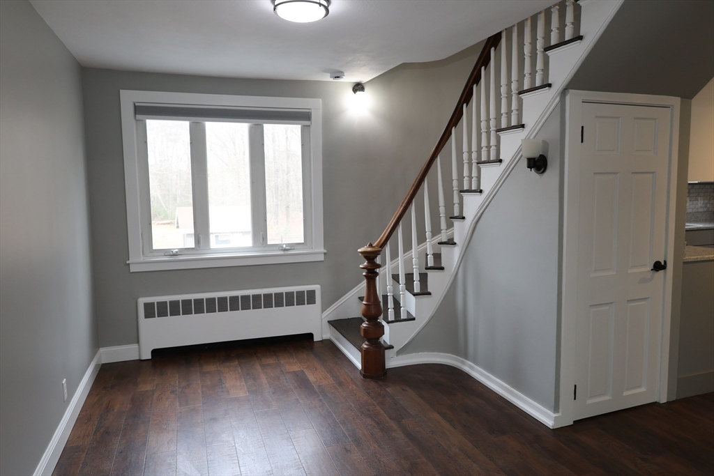 152 Central Street Georgetown, MA 01833 - Photo 15 of 26 a view of an empty room with wooden floor and stairs