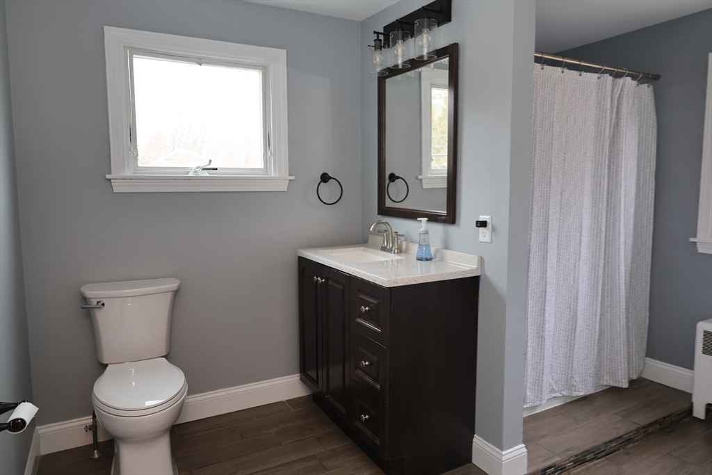 152 Central Street Georgetown, MA 01833 - Photo 16 of 26 a bathroom with a toilet sink vanity and mirror