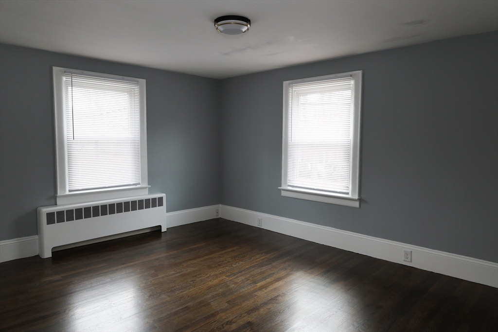 152 Central Street Georgetown, MA 01833 - Photo 17 of 26 a view of an empty room with wooden floor and a window