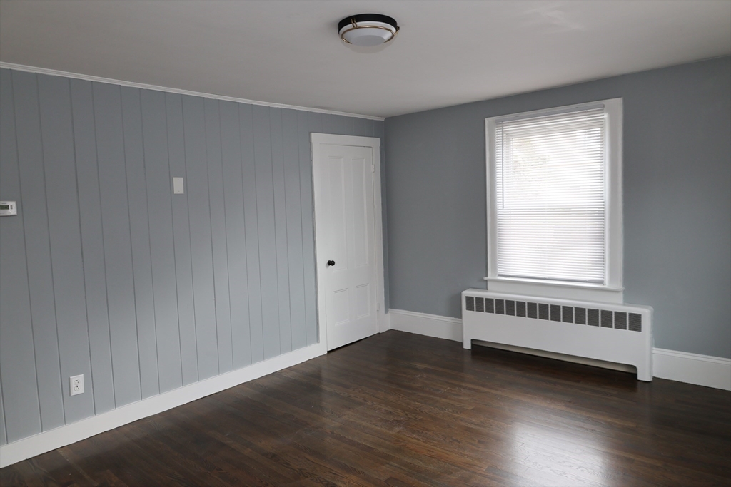 152 Central Street Georgetown, MA 01833 - Photo 18 of 26 an empty room with wooden floor and windows
