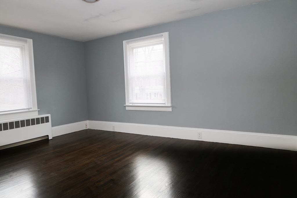 152 Central Street Georgetown, MA 01833 - Photo 19 of 26 an empty room with wooden floor and windows