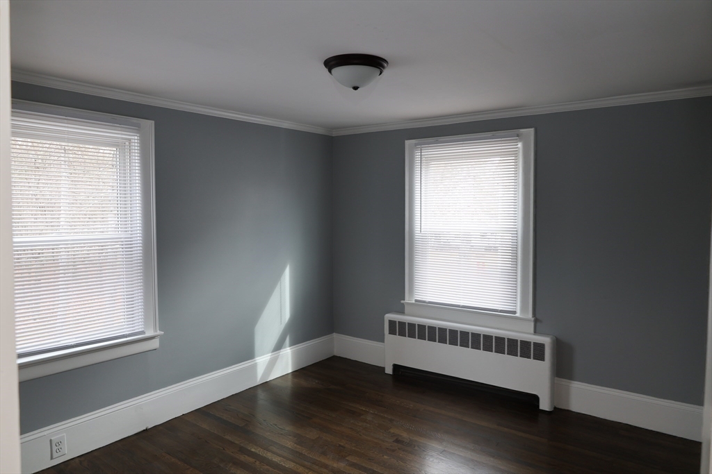 152 Central Street Georgetown, MA 01833 - Photo 20 of 26 a view of an empty room with wooden floor and a window