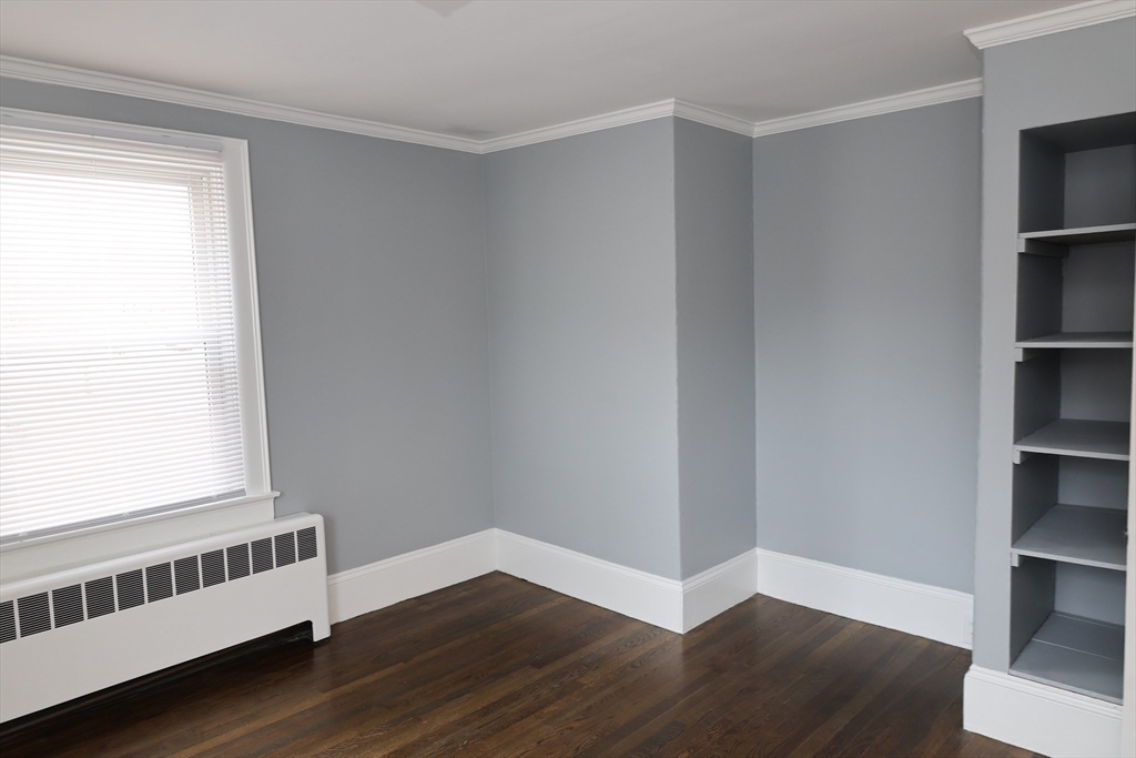 152 Central Street Georgetown, MA 01833 - Photo 21 of 26 a view of an empty room with wooden floor and a window