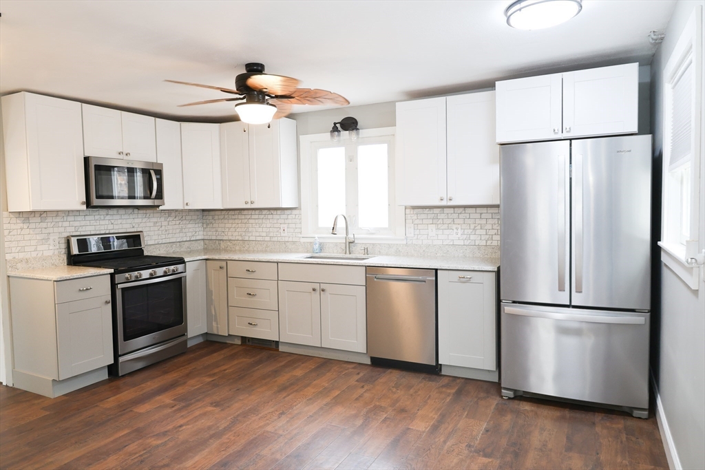 152 Central Street Georgetown, MA 01833 - Photo 6 of 26 a kitchen with stainless steel appliances a refrigerator sink and microwave