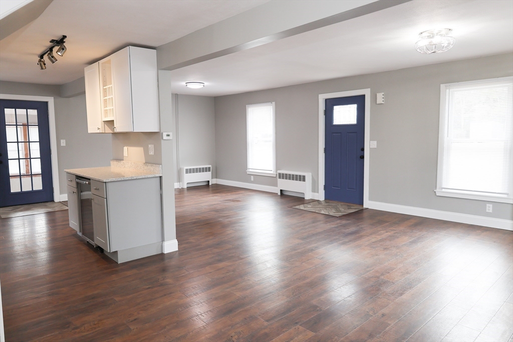 152 Central Street Georgetown, MA 01833 - Photo 8 of 26 an empty room with wooden floor and windows