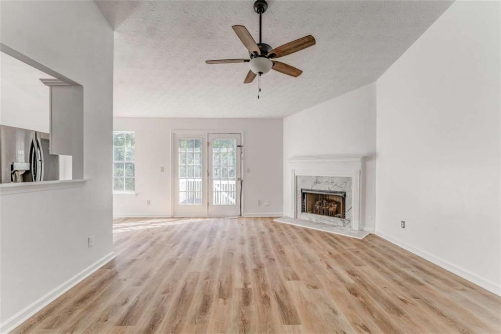 4379 Cross Lane Decatur, GA 30035 - Photo 5 of 19 a view of a livingroom with a fireplace a ceiling fan and windows