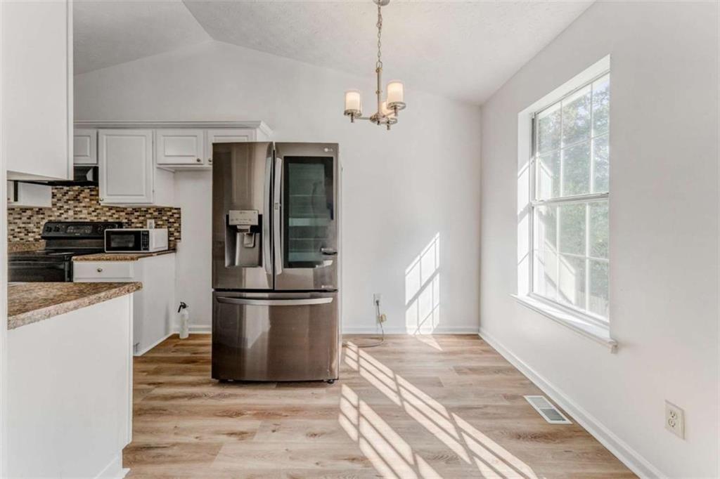 4379 Cross Lane Decatur, GA 30035 - Photo 7 of 19 a kitchen with stainless steel appliances granite countertop a refrigerator and a stove top oven
