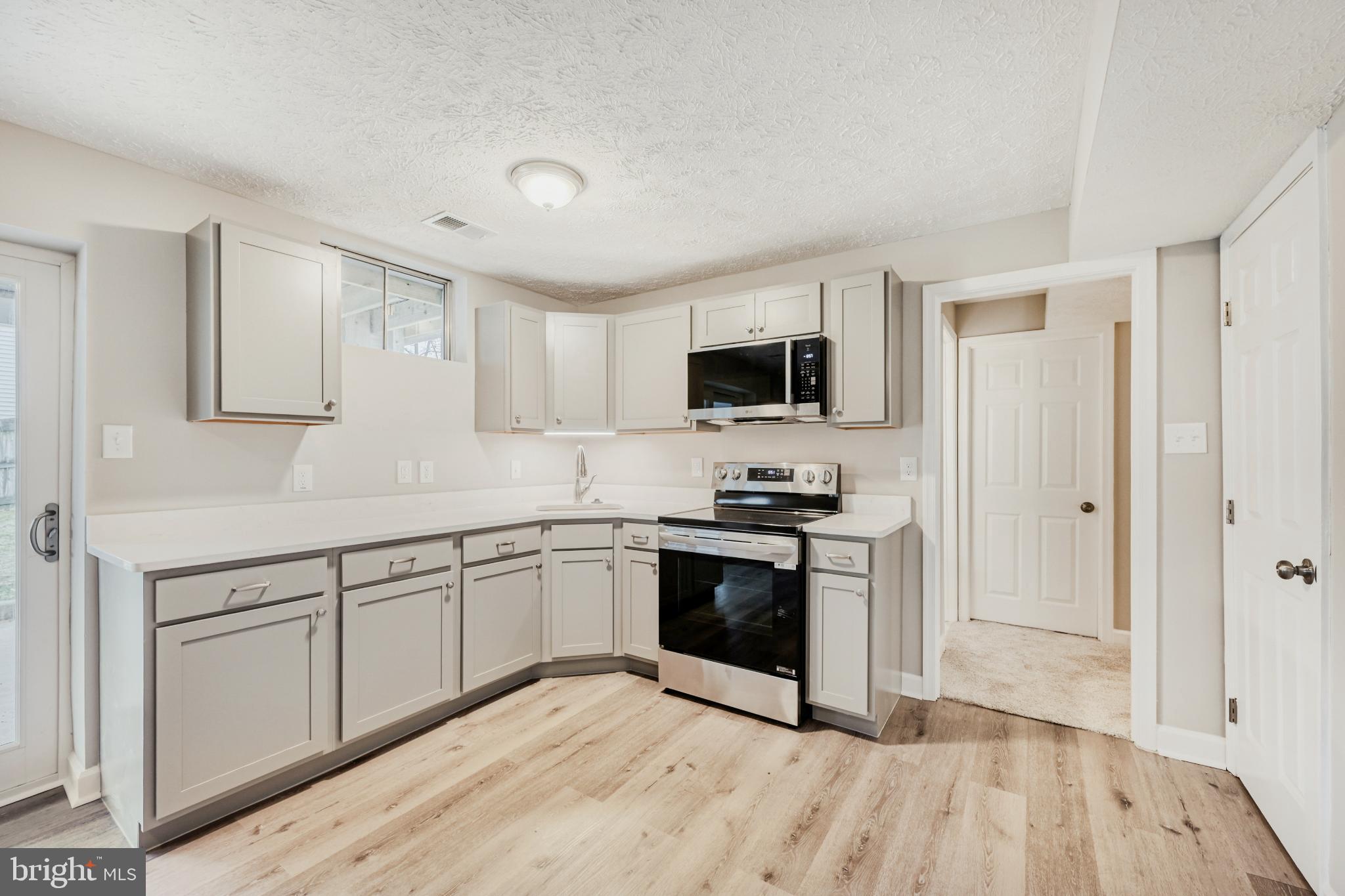 6351 Hanover Crossing Way Hanover, MD 21076 - Photo 17 of 34 Modern kitchenette with sleek cabinetry.