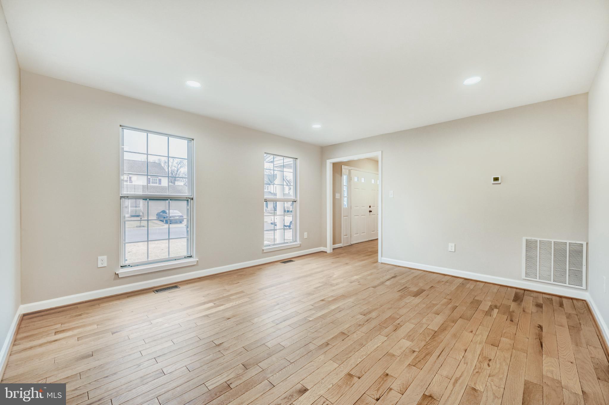 6351 Hanover Crossing Way Hanover, MD 21076 - Photo 19 of 34 Spacious, sunlit living room with hardwood floors.