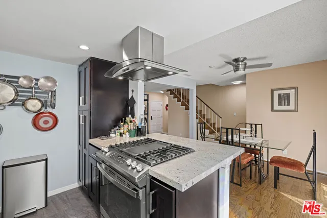 a kitchen that has a stove and a table